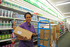 Woman at work stocking shelves in a retail establishment.