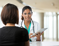 A woman talking to a doctor.