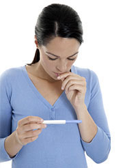 Woman looking at pregnancy test results
